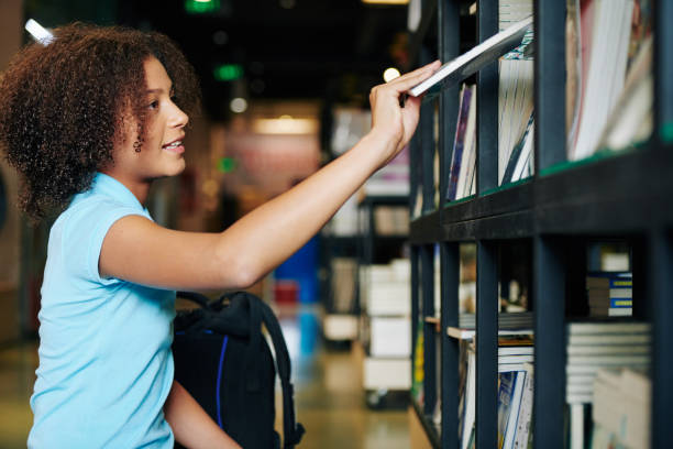 istock Girl Taking Book In Bookstore 1199214628
