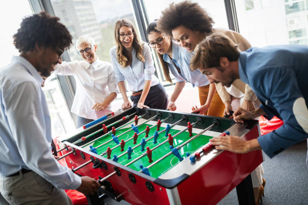istock Multiracial people having fun in office room, excited diverse employees enjoying activity at work 1199214818