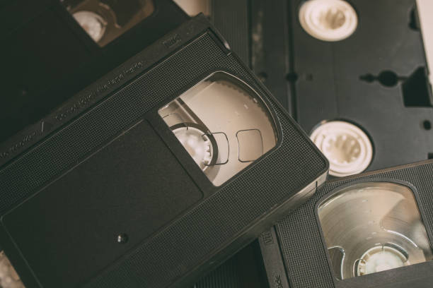istock Stack of VHS video tapes as background. Old video cassette tapes. Retro technology. 1199215083