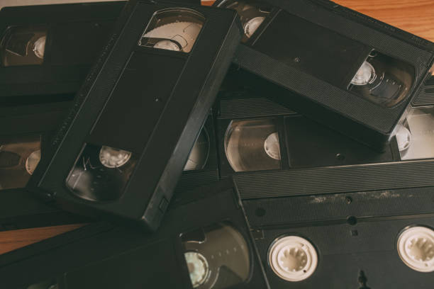 istock Stack of VHS video tapes as background. Old video cassette tapes. Retro technology. 1199215088