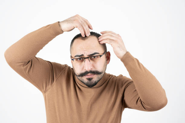 istock Man checking his hair 1199215182