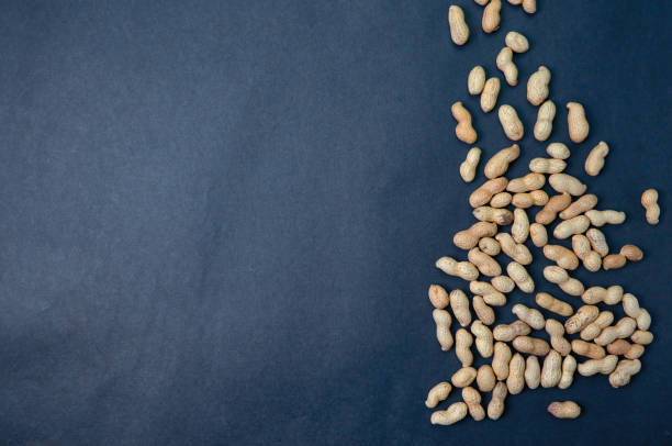 istock Handful peanuts on a dark background, top view with place for text. 1199216725