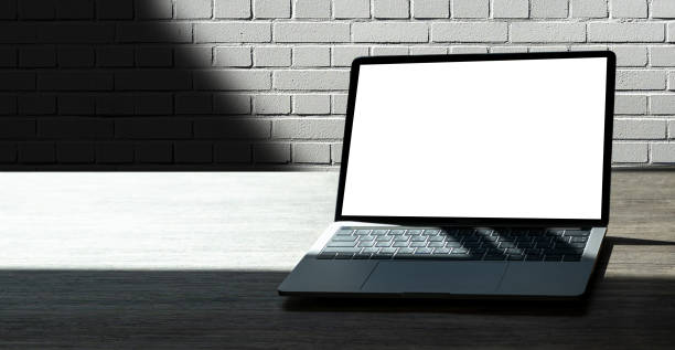 istock businessman using laptop at home Laptop with blank screen on table  notebook space 1199218269