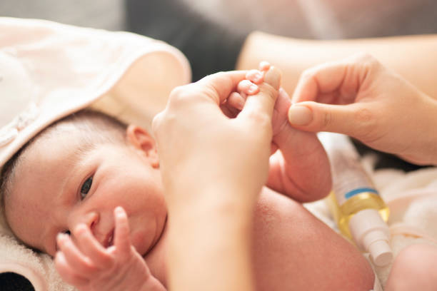 istock Mother makes massage with baby oil 1199218503