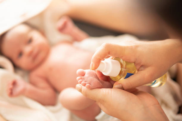 istock Mother makes massage with baby oil 1199218505