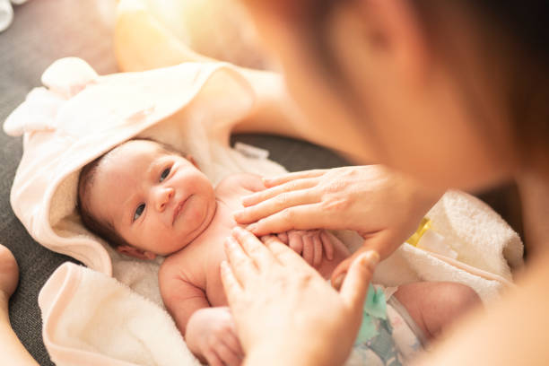 istock Mother makes massage with baby oil 1199218516