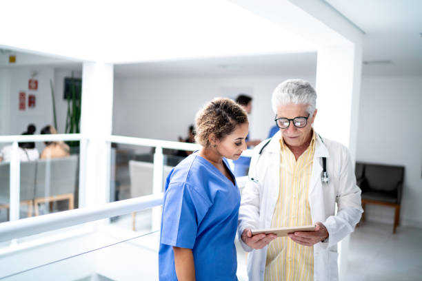 istock Doctor and nurse walking and using digital tablet at hospital 1199219589