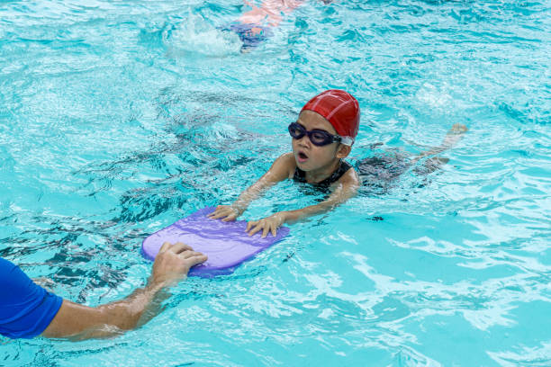 istock kids learn how to swim in swimming class 1199220556