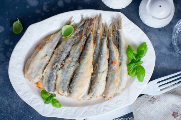 istock Whole grilled smelt fish on a white dish, selective focus, top view 1199223292