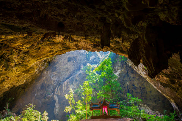 phraya nakhon cave in thailand,light shines through the cave to the tree. phraya nakhon cave, prachuap khiri khan, thailand - phraya nakhon cave imagens e fotografias de stock