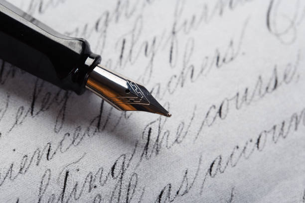 istock fountain pen on paper with ink text closeup 1199228122