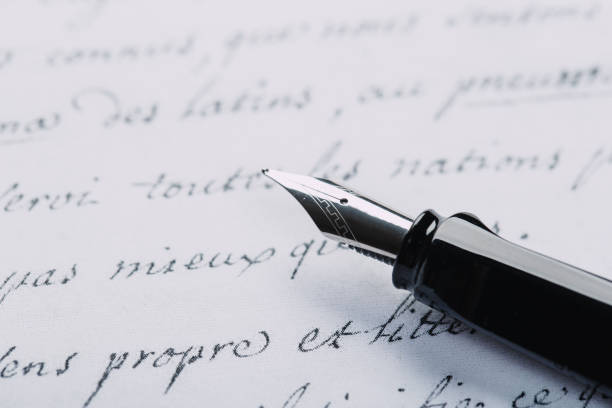 istock fountain pen on paper with ink text closeup 1199228141