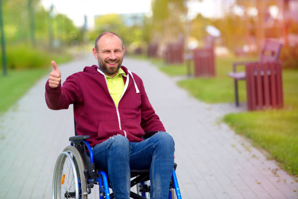 happy man on wheelchair showing OK stock photo