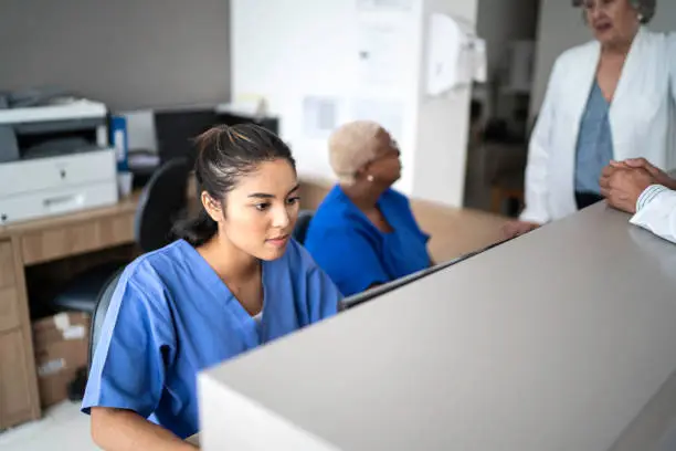 Photo of Secretary working at hospital reception