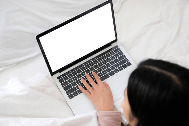 istock Woman hands typing laptop computer with blank screen for mock up template background, Laptop with blank screen backdrop for people business technology and lifestyle background concept 1199232750