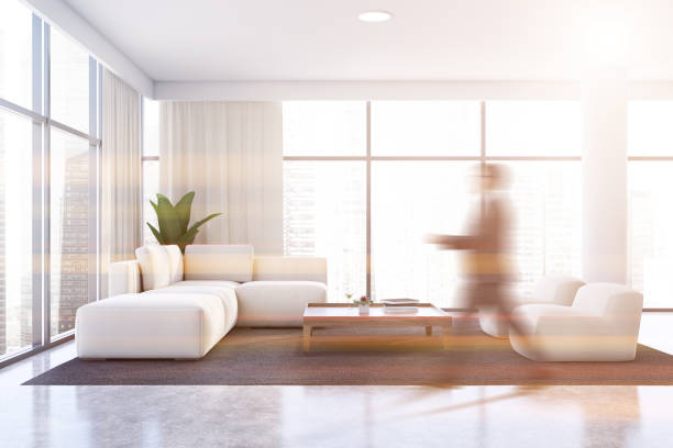 istock Man walking in white living room with sofa 1199233413