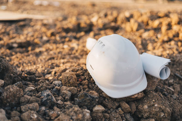 istock The White Safety Helmet and The Blueprint at Construction Site, Engineer Architect Construction Site Planning Concept 1199234275