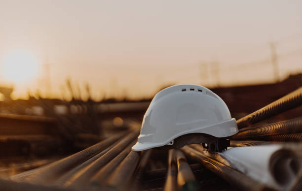 istock The White Safety Helmet and The Blueprint at Construction Site, Engineer Architect Construction Site Planning Concept 1199234288