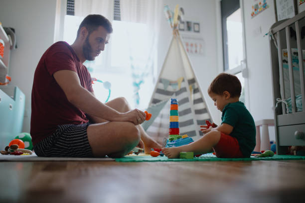 istock Father and son playing in kid room 1199234464