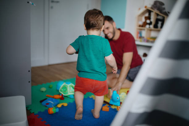istock Father and son playing in kid room 1199234537