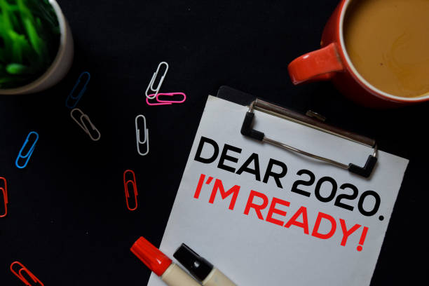 istock Dear 2020 I am Ready! write on Paperwork isolated on black board background. 1199235881