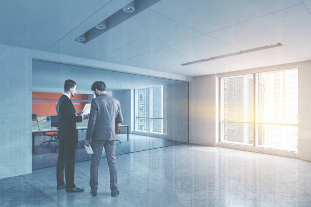 istock Businessmen in white open space office lobby 1199236781