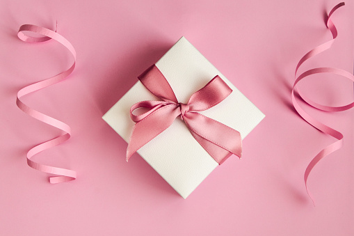 White gift box with pink ribbon on the pink background, Holiday Concept, Present, Banner