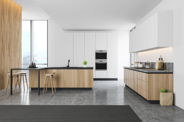 istock Spacious white and wooden kitchen with bar 1199237553
