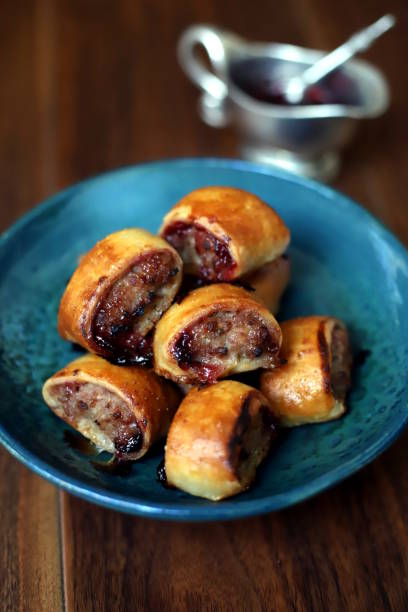 istock Fresh baked cranberry sausage rolls in a blue bowl 1199239374