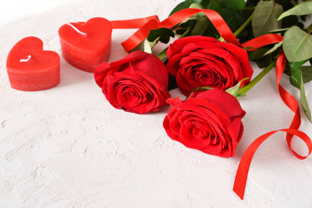 istock Red roses on concrete background. Beautiful red roses for Valentine's Day. 1199240120