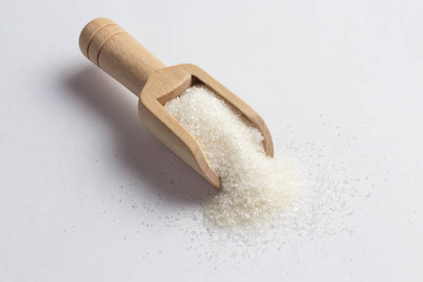istock White sugar in wooden scoop 1199241510