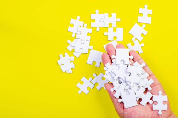 istock Jigsaw and hands on the yellow concept background 1199241563
