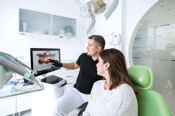 Dentist talks to her patient about three-dimensional smile design Dentist talks to her patient about three-dimensional smile design 3d scanning photos stock pictures, royalty-free photos & images
