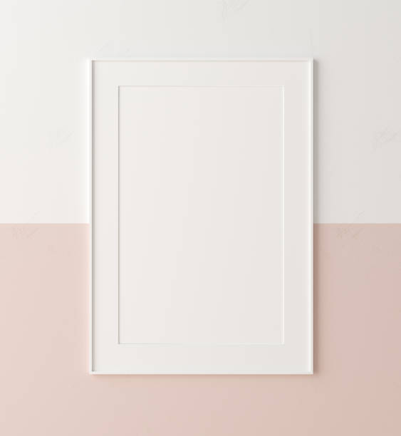 cornice poster mockup da vicino su parete dipinta di colore bianco e rosa pastello - poster blank wall picture frame foto e immagini stock