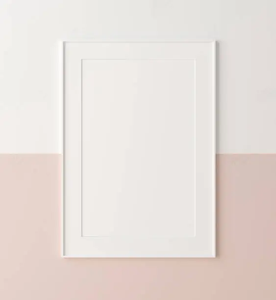 Photo of Mockup poster frame close up on wall painted white and pastel pink color