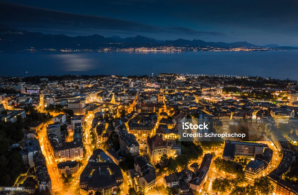 Lausanne Cityscape in Switzerland Aerial view of Lausanne Cityscape illuminated at dusk. Lake Geneva in the background. Vaud canton in Switzerland. Lausanne Stock Photo