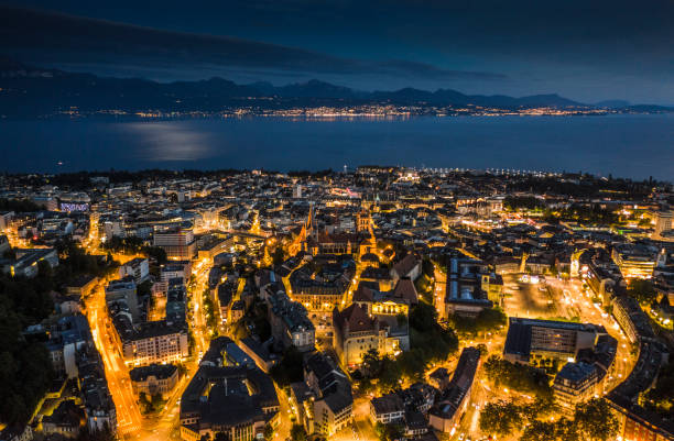 Lausanne Cityscape in Switzerland Aerial view of Lausanne Cityscape illuminated at dusk. Lake Geneva in the background. Vaud canton in Switzerland. montreux photos stock pictures, royalty-free photos & images