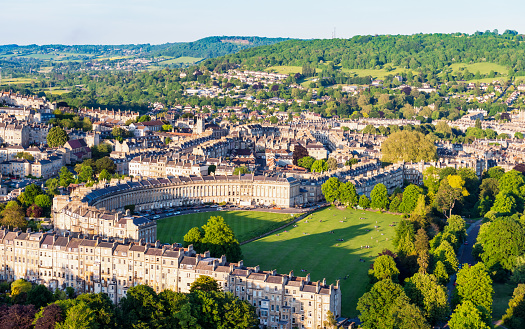 Royal Crescent, one of Bath's most famous historic streets, and the lawns, parkland and other streets surrounding it. Photographed from a hot air balloon.