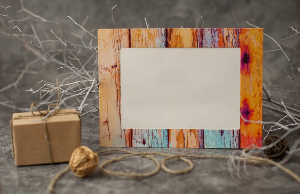istock Holiday background for Valentine's Day on a gray cement background with white painted branches and colorful frames with place for text. 1199246488