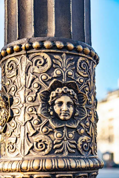 2019 Streetlight close up in Paris with a clear winter sky in the background.