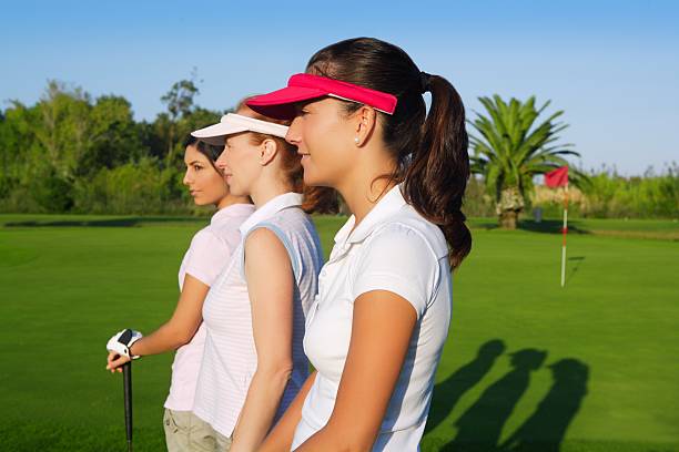 istock Golf three woman in a row green grass course 119924700