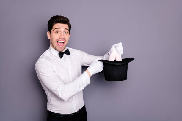 istock Wow omg rabbit in cylinder hat. Excited crazy funny wizard hold cap make focus to entertain circus audience wear white shirt black bow isolated over grey color background 1199248200