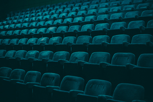 Plush, turquoise colored theater empty seats