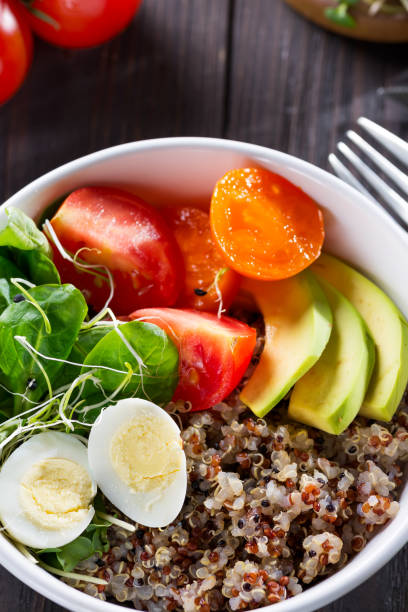 istock Vegetarian breakfast with quinoa, eggs, microgreen and vegetables, green tea with mint on a dark wooden table, flat lay 1199250046