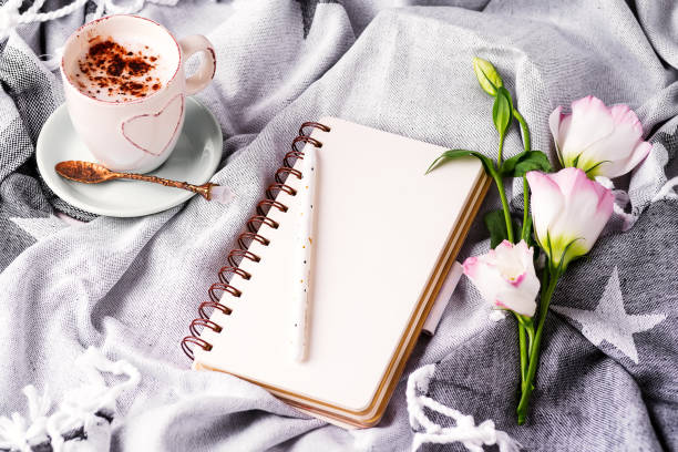 istock Open empty notebook and bouquet of flowers eustoma on blanket background. Beautiful greeting card in vintage style. Flat lay. 1199251322