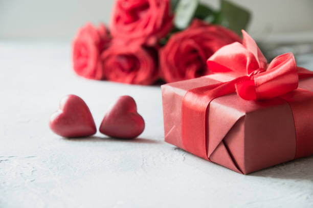 istock Valentines day greeting card with romantic gift, red roses, sweets. Space for text. 1199251895