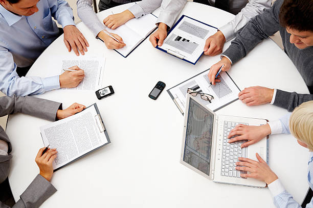 istock Business people sitting around a round table 119925276