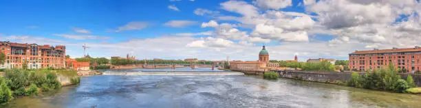 Summer city landscape, panorama, banner - view of the Garonne river in the city of Toulouse, in the historical province Languedoc, the region of Occitanie of southern France