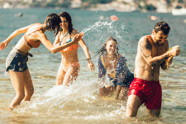 istock Happy friends having fun on beach 1199254417