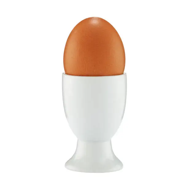 An egg in an eggcup on white with clipping path